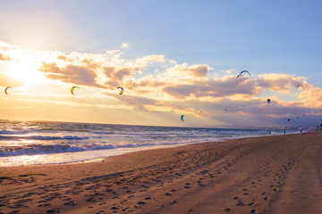 Obraz premium landscape of a beach in marbella with kite surfers in the ocean