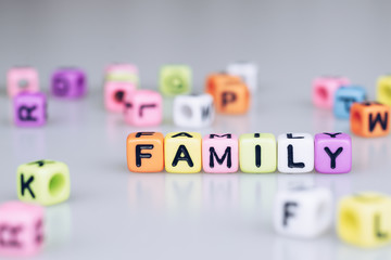 Family word text written on colorful cube with bokeh cube word block background