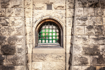 Small arched window with lattice in old historic building in Melbourne - architectural detail closeup