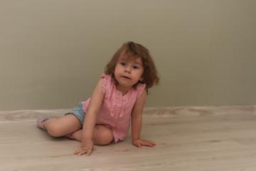 Young kid playing on a floor in a room