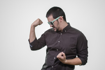 man with euphoric shirt, celebrating with arms raised