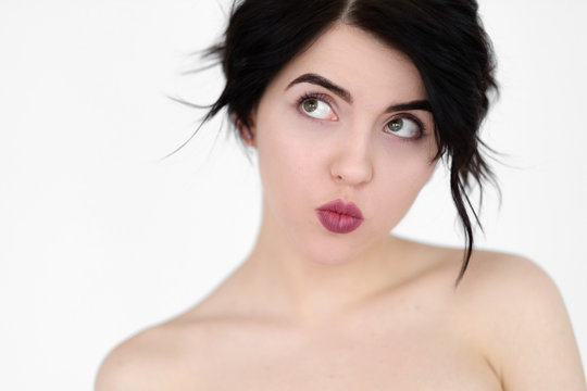 emotion face. playful coquettish naughty frolicsome flippant childish woman. pin up style pout. young beautiful brunette girl portrait on white background.