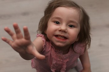 Young kid playing on a floor in a room