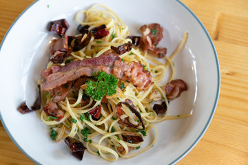 Delicious spaghetti with bacon on wooden table