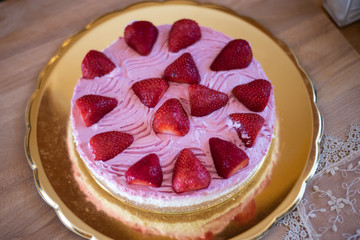 A delicious cake of cream and strawberries after sunday lunch