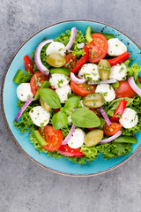 Vegetable salad with cheese mozzarella, tomatoes, basilikum and spice.