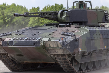 Fototapeta na wymiar German infantry fighting vehicle drives on a street