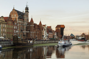 Fototapeta na wymiar Ancient colored houses on the promenade of the river in Gdansk at sunset. Poland