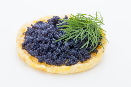 Canapes with black sturgeon caviar and  dill. Isolated on the white background.