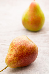 Fresh pears with leaves in a on wooden background.