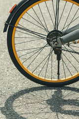 details of city bicycle gear and wheel with beautiful shadow in sunlight