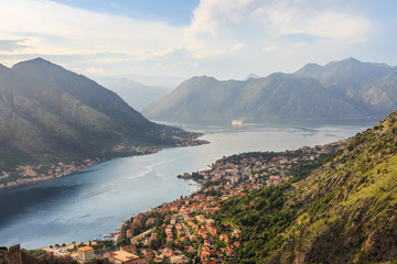 Panoramic view from above on the old city Kotor, bay in Adriatic sea and mountains in Montenegro at sunset time, gorgeous nature landscape