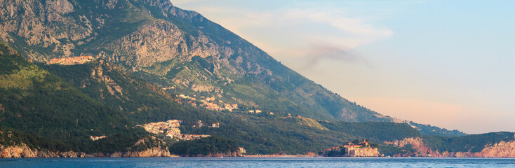 Obraz premium Adriatic sea coast with mountains in Montenegro, view on Sveti Stefan island at the sunset time, nature landscape
