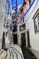 Fototapeta na wymiar Streets adorned with garlands in Alfama, Lisbon