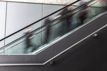 Fototapeta na wymiar Blurred motion of people on escalator in Melbourne CBD
