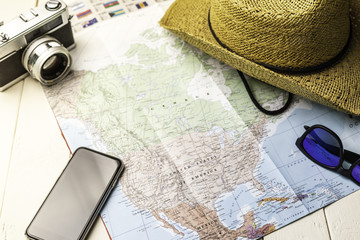 Fototapeta na wymiar Background accessories for traveling with america map, photo camera etc.