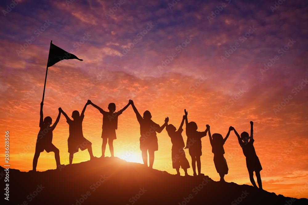 Wall mural silhouettes of children standing in a row holding hands.