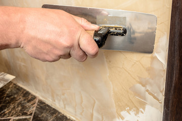 Stretching the second layer of Venetian plaster by man
