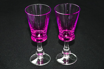 glasses purple stacks on black background