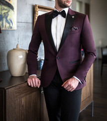 Male model in custom tailored tuxedo, suit posing indoors