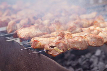 Pork meat smoked on hot charcoal barbecue, traditional shashlik