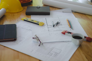 Architectural plans work space top view. Architectural project, blueprints,pencil and divider compass on wooden desk table.Construction background.Engineering tools. Copy space.Architectural Concept