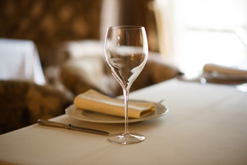 Table setting with an empty glass for wine.