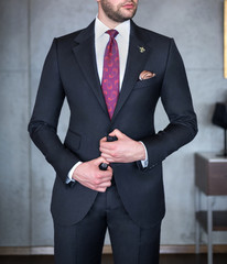 Man in custom tailored business suit posing indoors