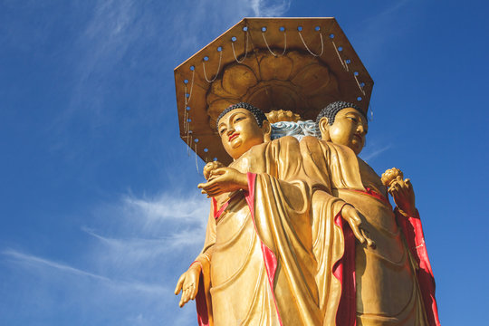 Buddha statue in the sun with blue sky in the background