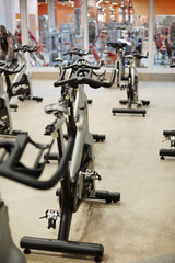Fitness bikes in gym or contemporary leisure center with nobody around