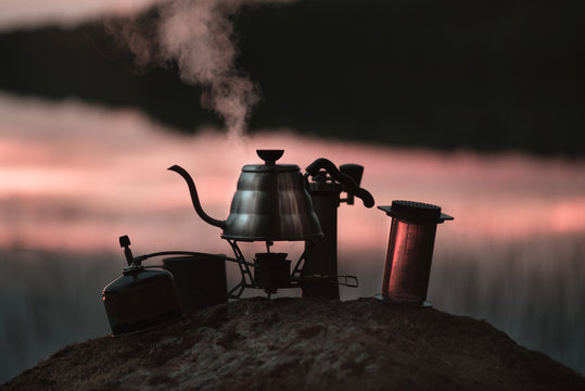 boiling kettle and coffee or tea accessories in the evening or morning in the woods