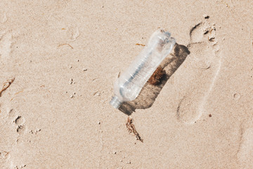 Ecological foot print and plastic waste on ocean beach