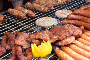 wrapped white sausage on the grill in the company of other sausages
