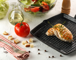 grilled chicken with spices on black grill pan for salad
