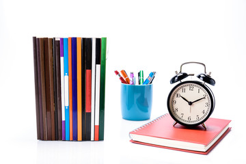 Mockup of Business or education concept : pile of  books , black alarm clock put on diary book with...