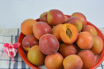 Apricots in a tray on a white background