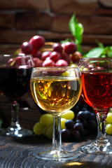 wine glasses on a dark wooden background, vertical