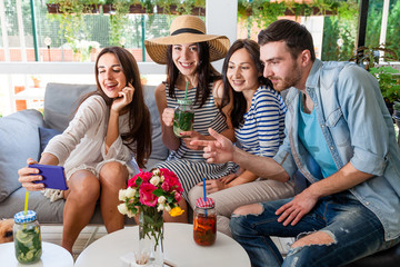 young people cafe talk communicate summer drinks cocktail together group happy smile girl boy man woman green leaves white