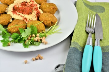Falafel on a plate around hummus