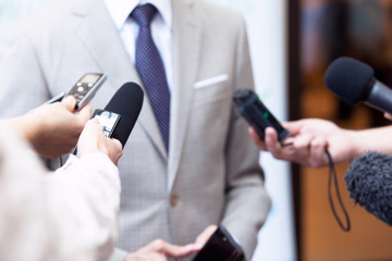 Journalists making media interview with unrecognizable business person or politician