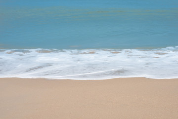 Fototapeta na wymiar Soft waves on the sand beach