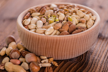 wooden bowl full of different muxture variety of nuts 