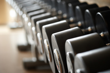 Fototapeta na wymiar Closeup image of dumbells on a stand. Gym equipment