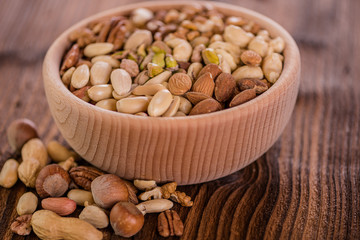 wooden bowl full of different muxture variety of nuts 
