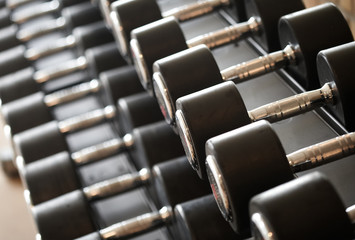 Obraz premium Closeup image of dumbells on a stand. Gym equipment