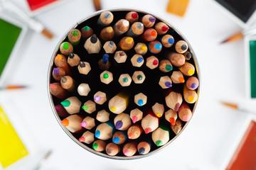 Large set of colored pencils pointing up - top view