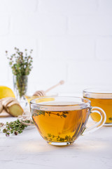 Winter drink. Warming hot tea with lemon, ginger, and herbs thyme, copy space