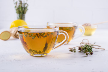 Winter drink. Warming hot tea with lemon, ginger, and herbs thyme, copy space