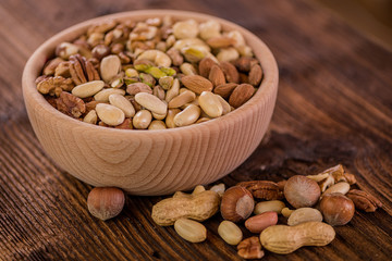 wooden bowl full of different muxture variety of nuts 