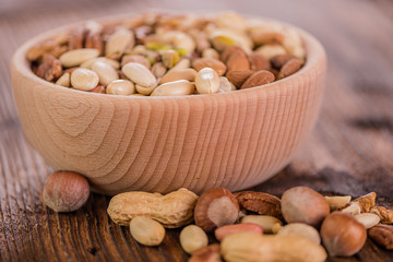 wooden bowl full of different muxture variety of nuts 